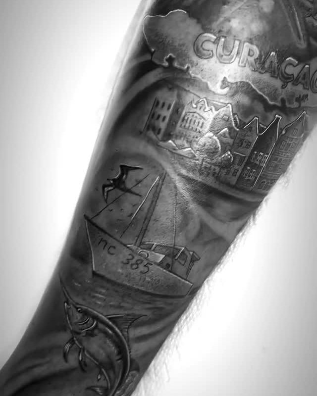 Blackwork forearm sleeve with Curaçao lettering, a sailing ship and a skyline