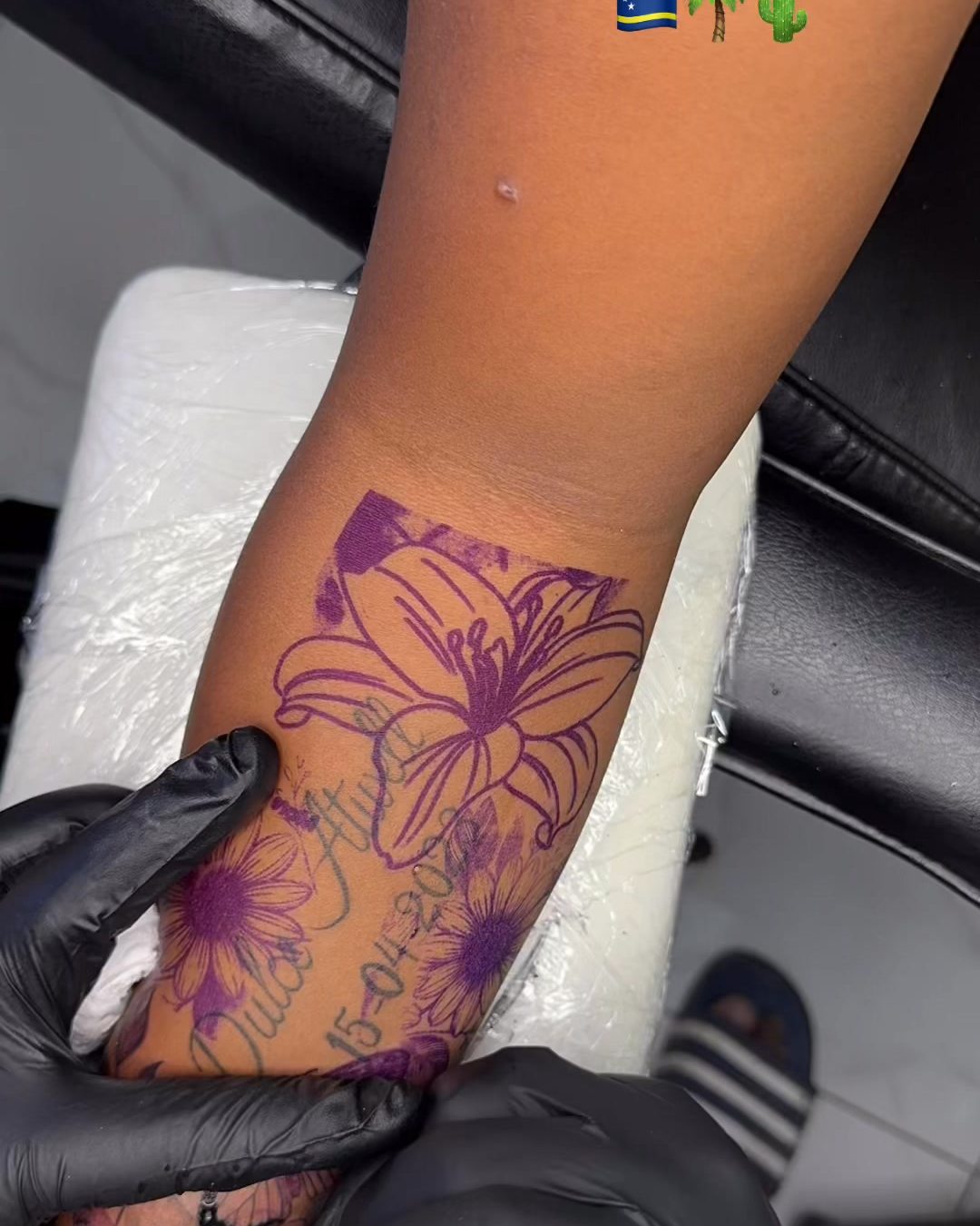 Purple stencil transfer lines of a floral design on a leg before tattooing